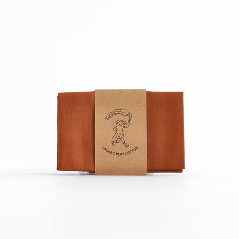 A folded brown paperboard box with a kraft paper band around the middle, featuring a simple line drawing and the text 'LADIES' PLAY COTTON', centered on a plain white background.