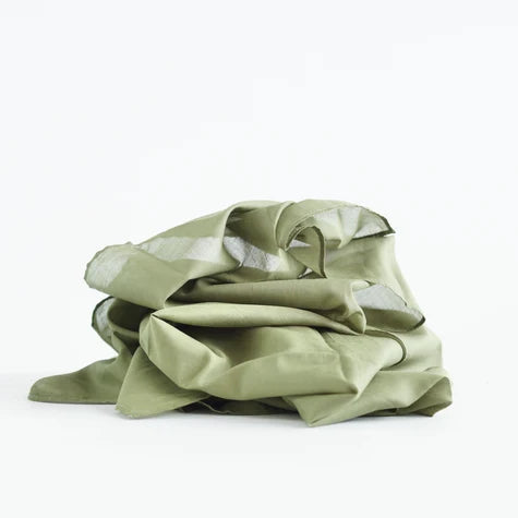 Green fabric crumpled on a white background