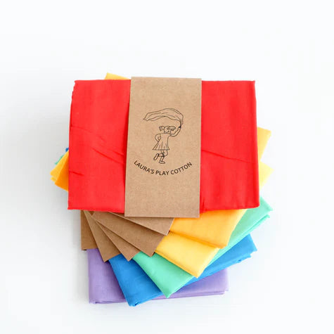 Set of colorful fabric squares with a brown paper bag on a white background