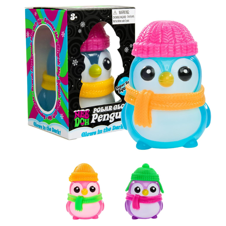 A set of glow-in-the-dark polar bear penguin toys shown with their retail box and two small unboxed variants. The main product is a blue and white penguin wearing a pink knit hat and yellow-orange scarf, with the box and two smaller versions in pink, green, and purple winter outfits on a plain white background.