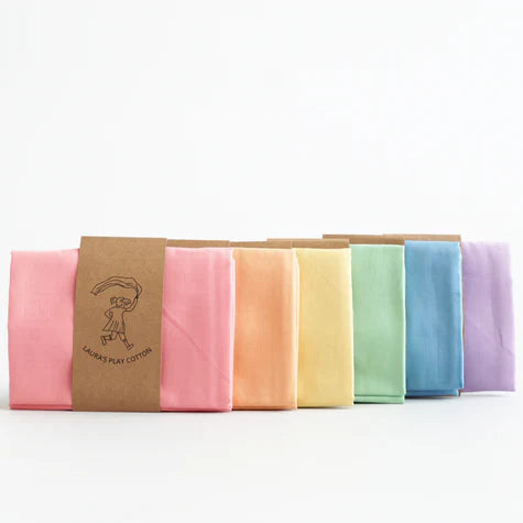 Set of colorful fabric swatches with a brown cardboard holder on a white background